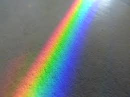 A rainbow over a sidewalk