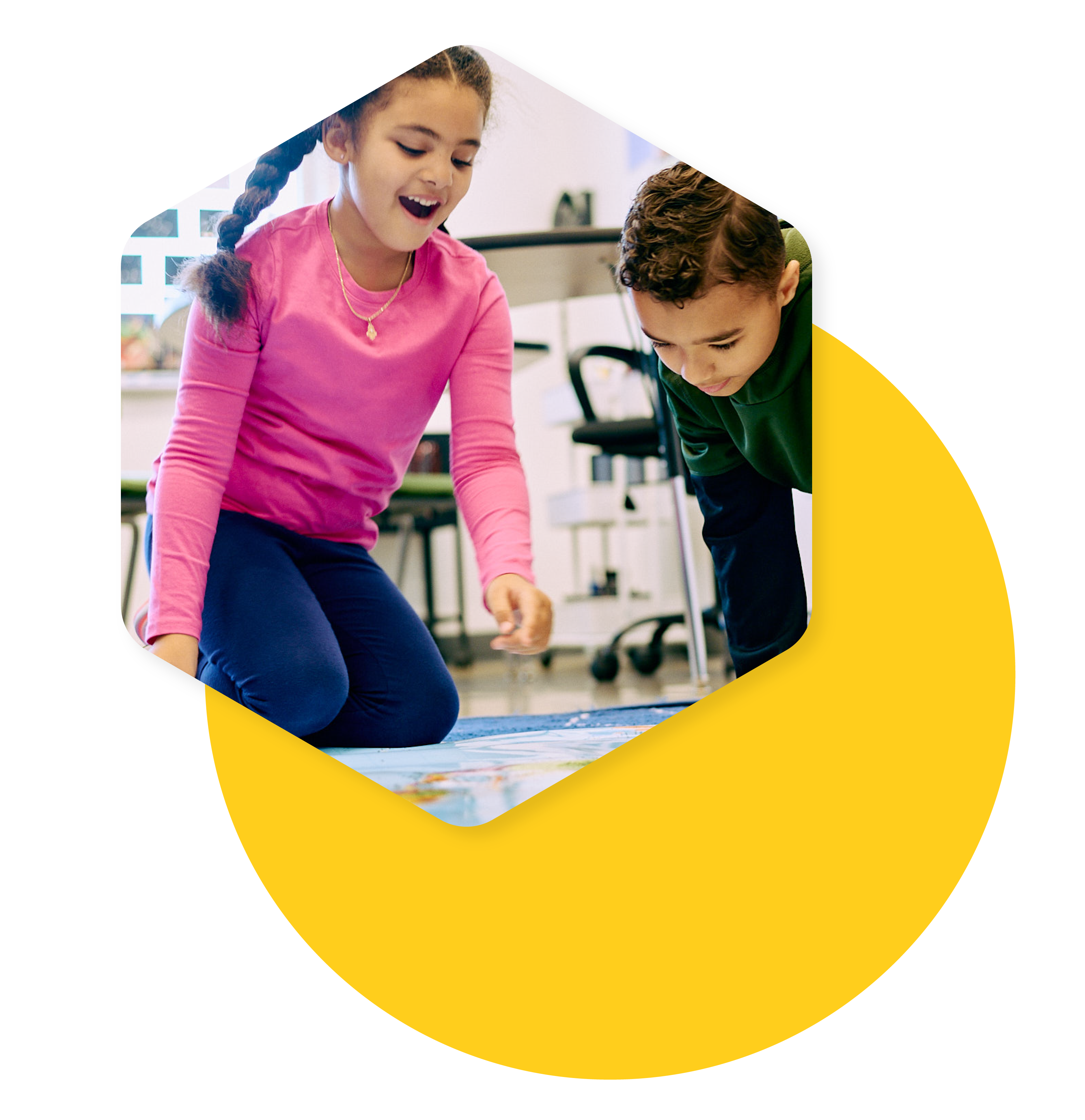 small girl and boy playing with a map on a classroom floor